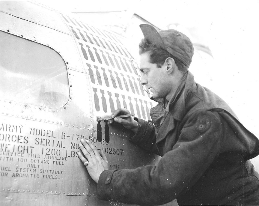 Cpl. David Cohen, 600th Mechanic painting A/C 42-102507 - 1944